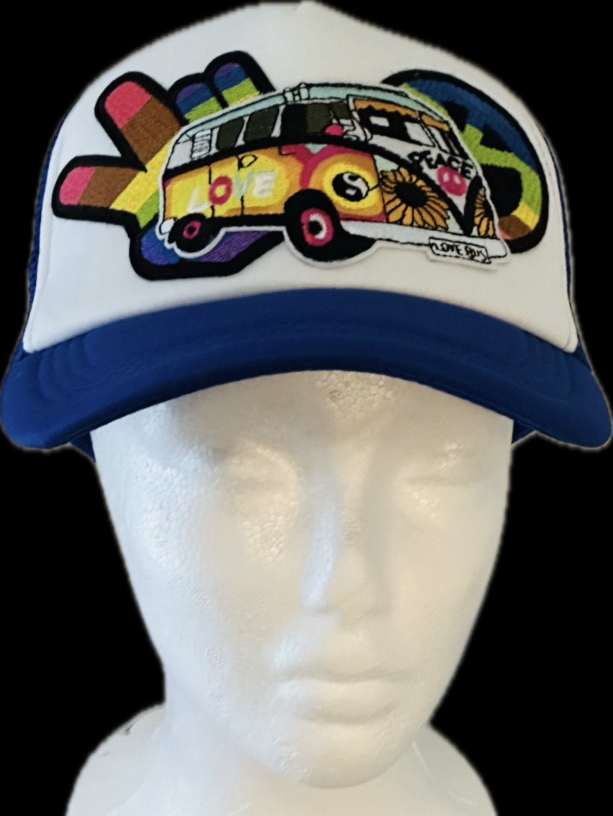 Royal blue and white trucker with a VW bus, Love and Peace patch on a mannequin