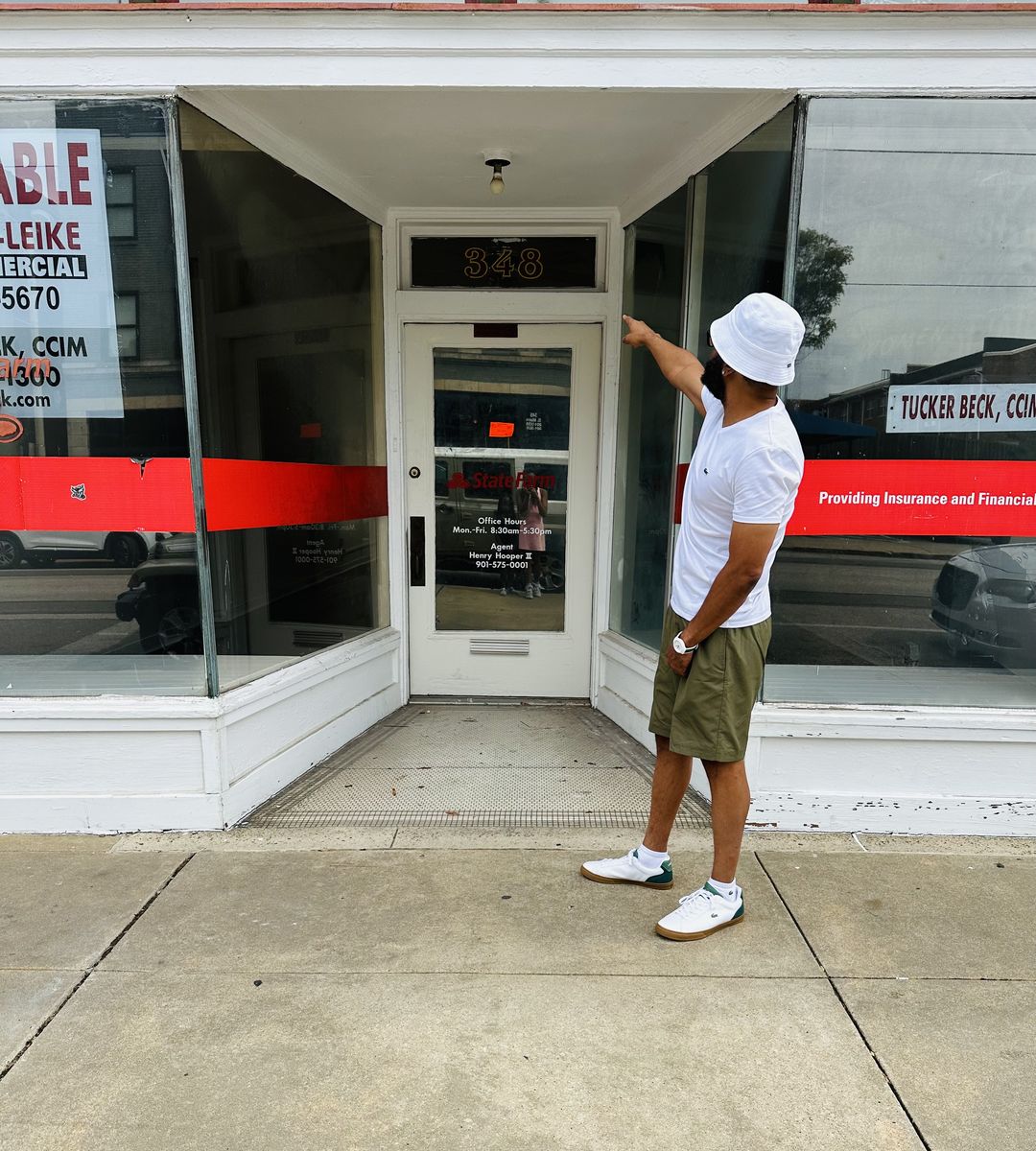 Marlon Thomas pointing to the door of The Cap Bar at 348 South Main Street in Memphis